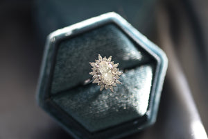 Finished platinum snowflake halo engagement ring in its Luvari presentation box